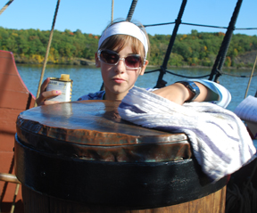 Evi polishes the metal top of the capstan.