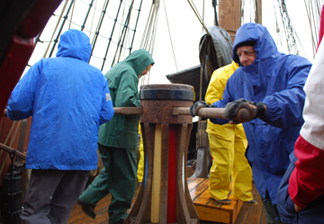 The crew walks the capstan.