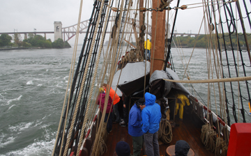 The Half Moon rolls across the turbulent Hell Gate.