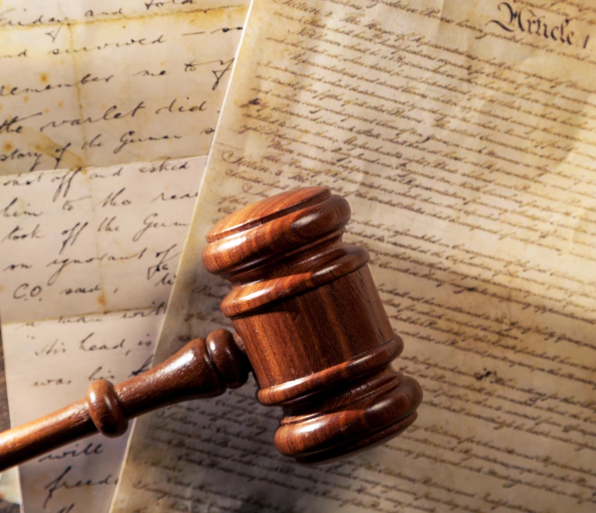 Legal gavel with vintage manuscripts