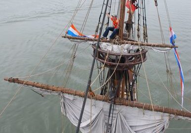 Historic ship sailing near city skyline